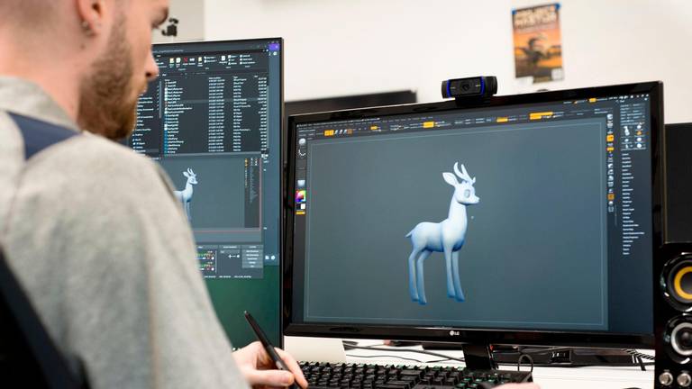 Landon working on 3D computer model of a deer